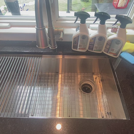 Cleaning black granite countertops and Kraus stainless steel sink with Supreme Surface Daily Stone Cleaner, Granite Quartz & Marble Treatment, and Scum  Mineral Deposit Remover. 